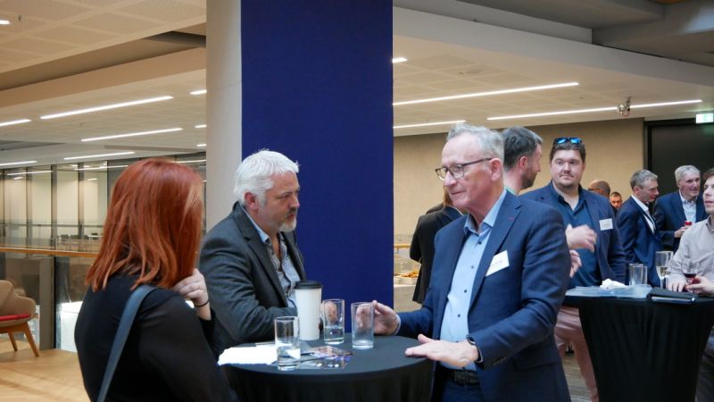 three people networking at event