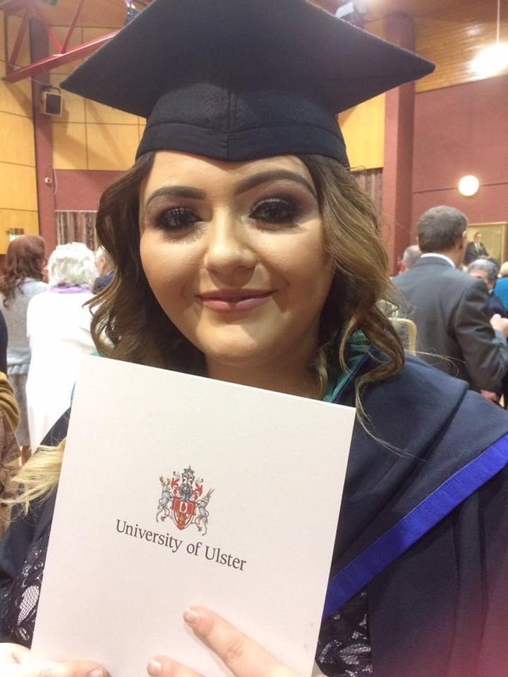 lady in graduate robe with certificate 