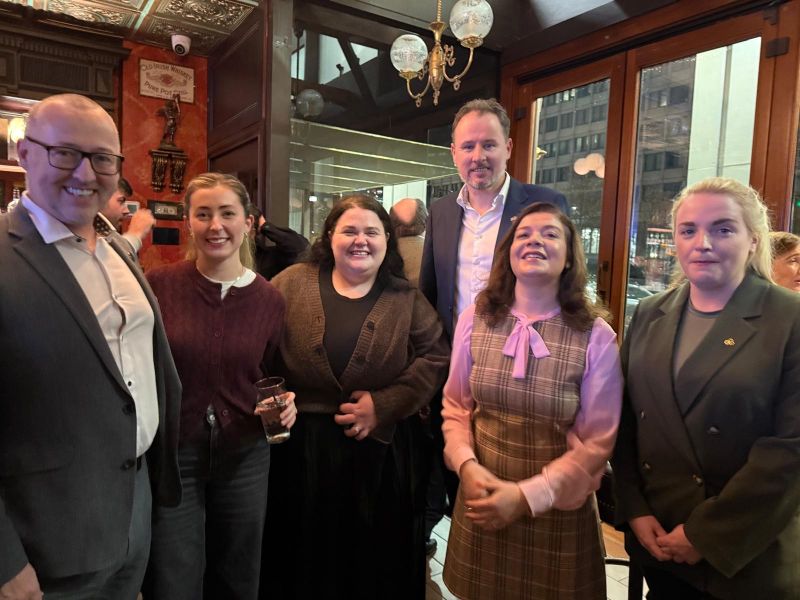 group of males and females gathered in a bar