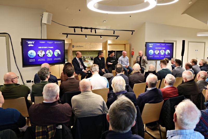 Wide angle picture of IMD Speakers and Host Stephen Watson, Andrew Hill,  Glen Irwin, Andy Chapman & Danny Campbell with a shot of the IMD crowd
