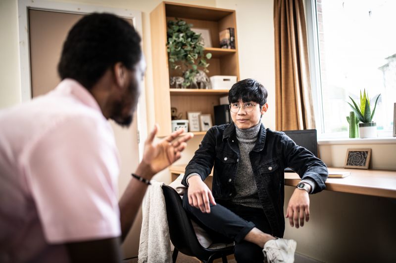 Two men sitting down in conversation