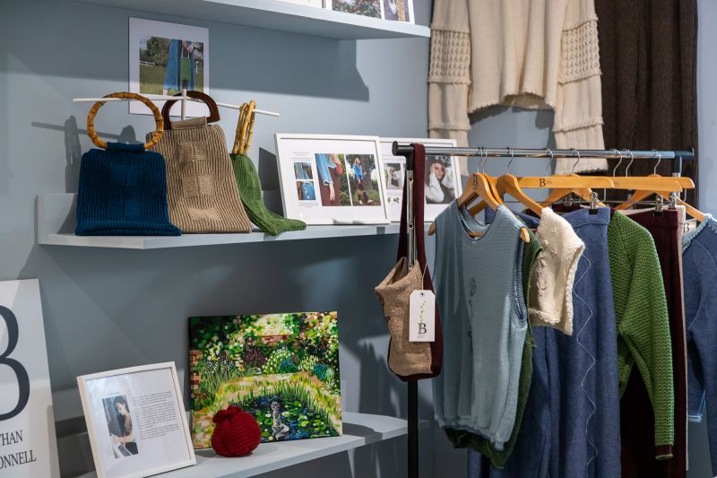 A rail of clothing featuring Bethan's knitwear. 