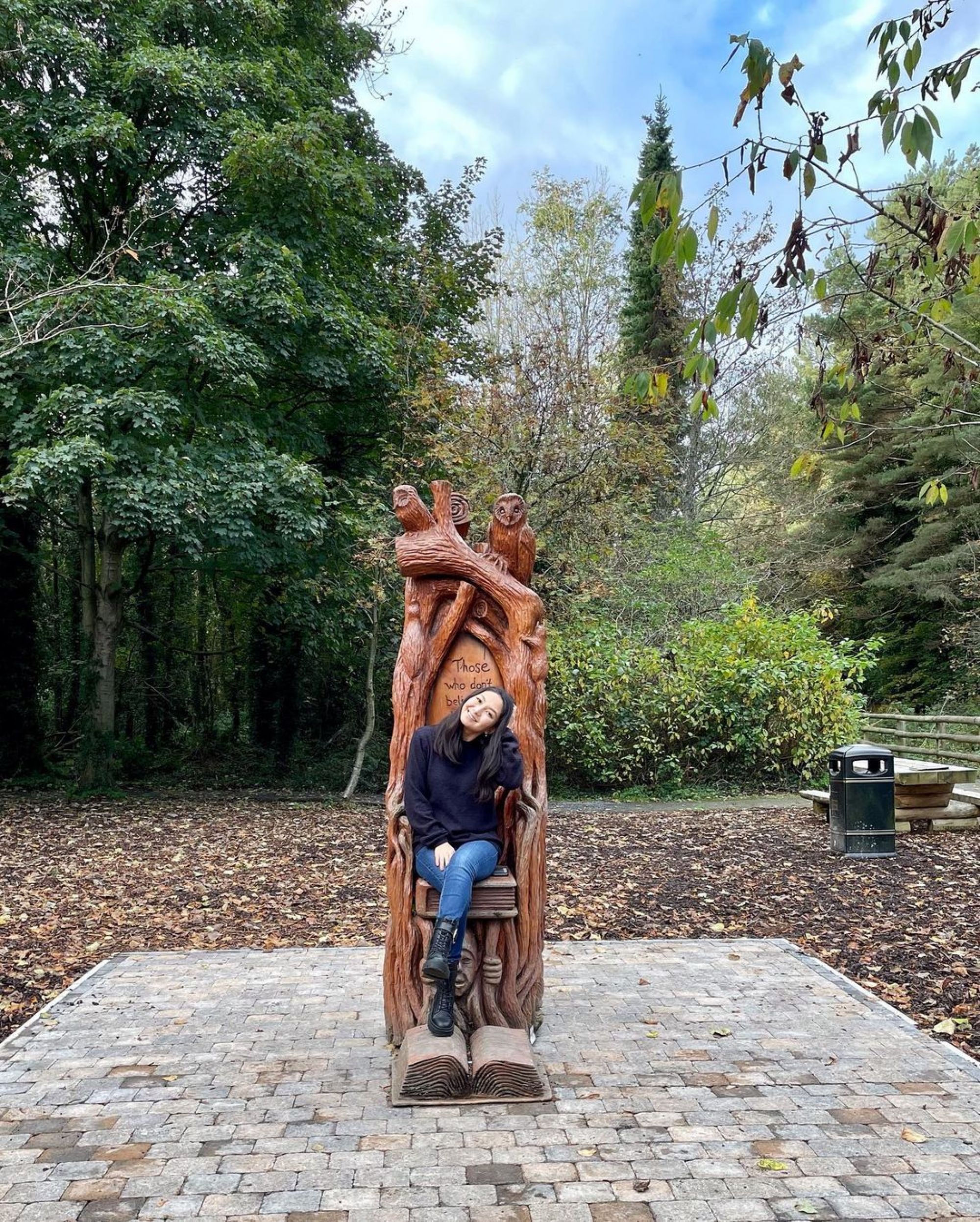 Yerke sitting on a wooden crafted chair in a forest