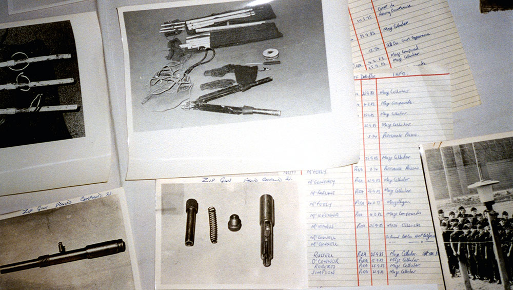 An array of objects and artefacts collected from HMP MAZE prison laid out on a table