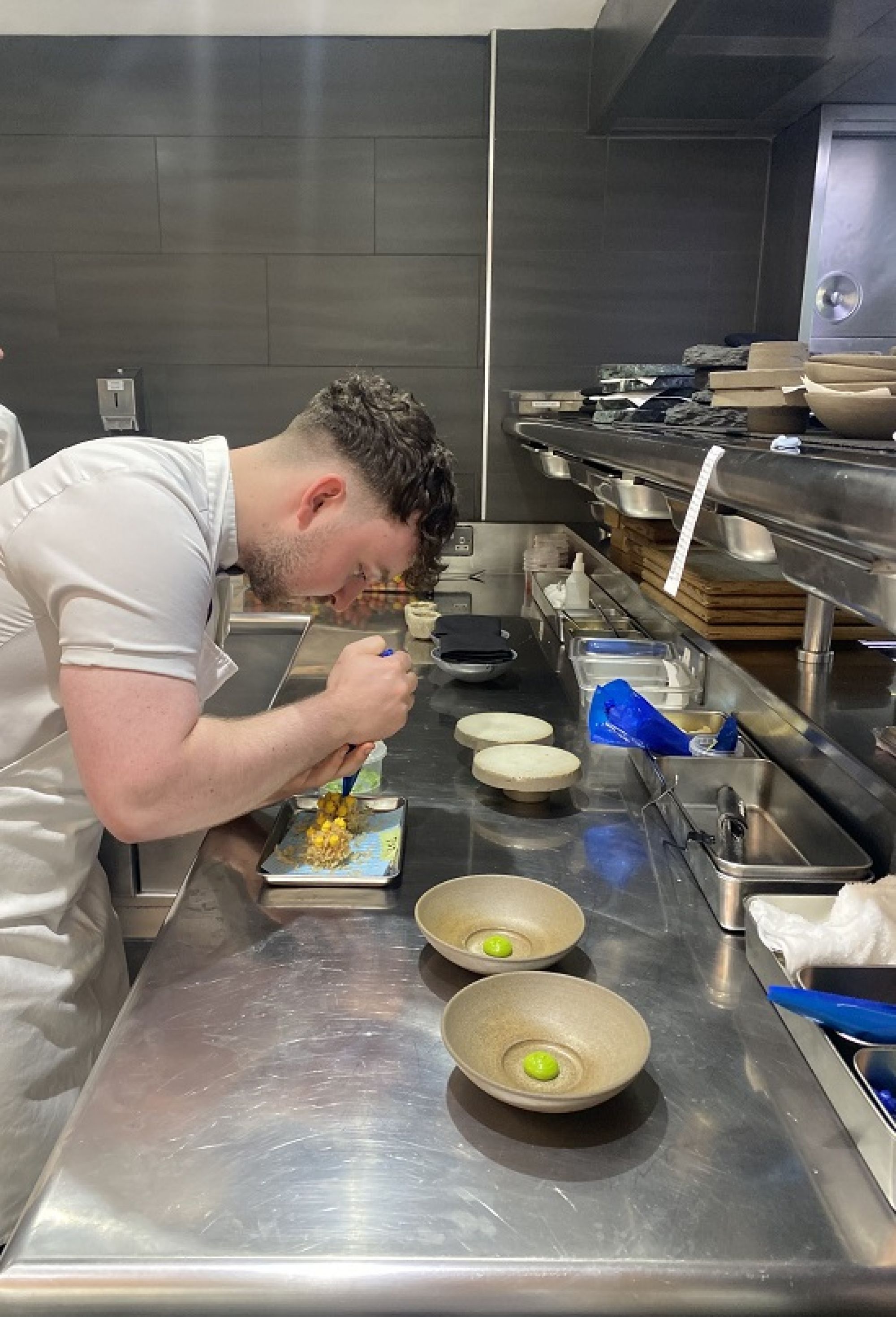 Lewis prepping food in the kitchen
