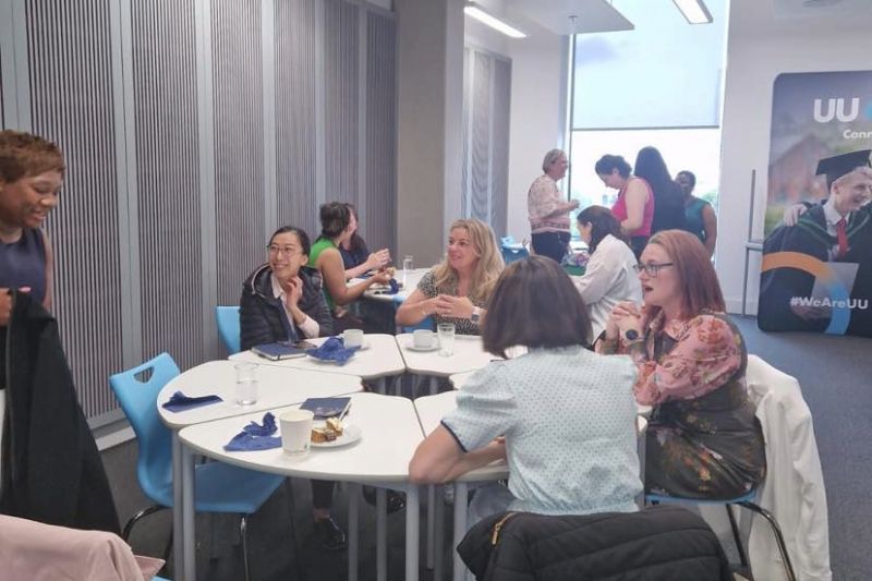 women sitting around table in discussion