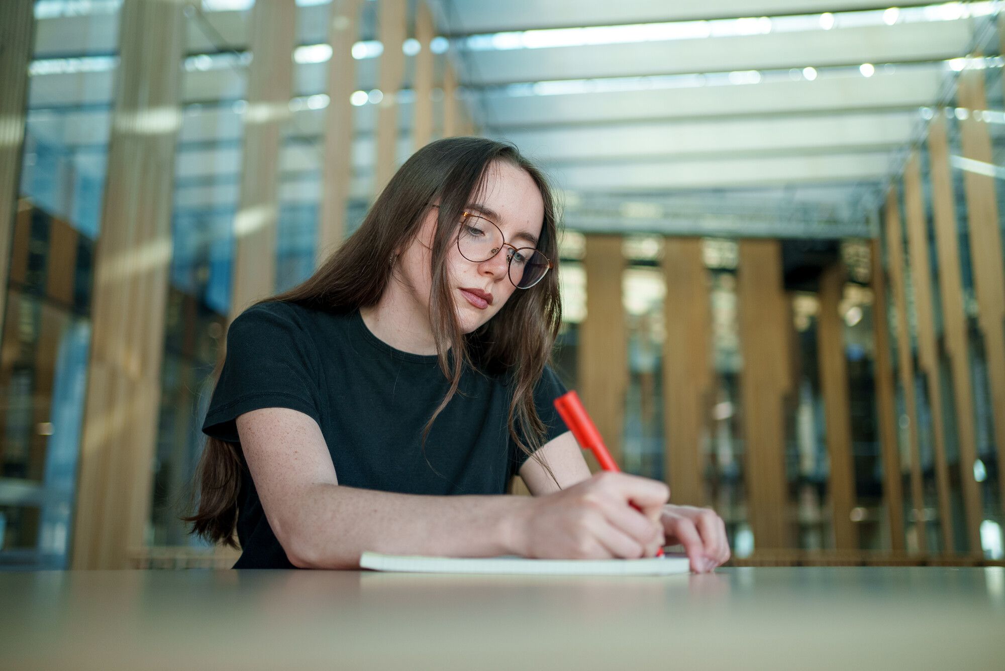 Male student holding a laptop under his arm