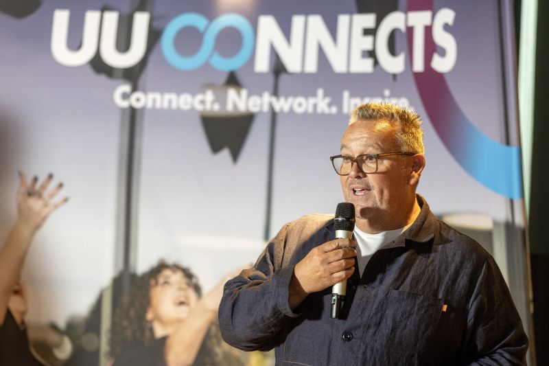 Ardmore founder and group CEO John Keane talking into a microphone in front of a UU Connects sign.
