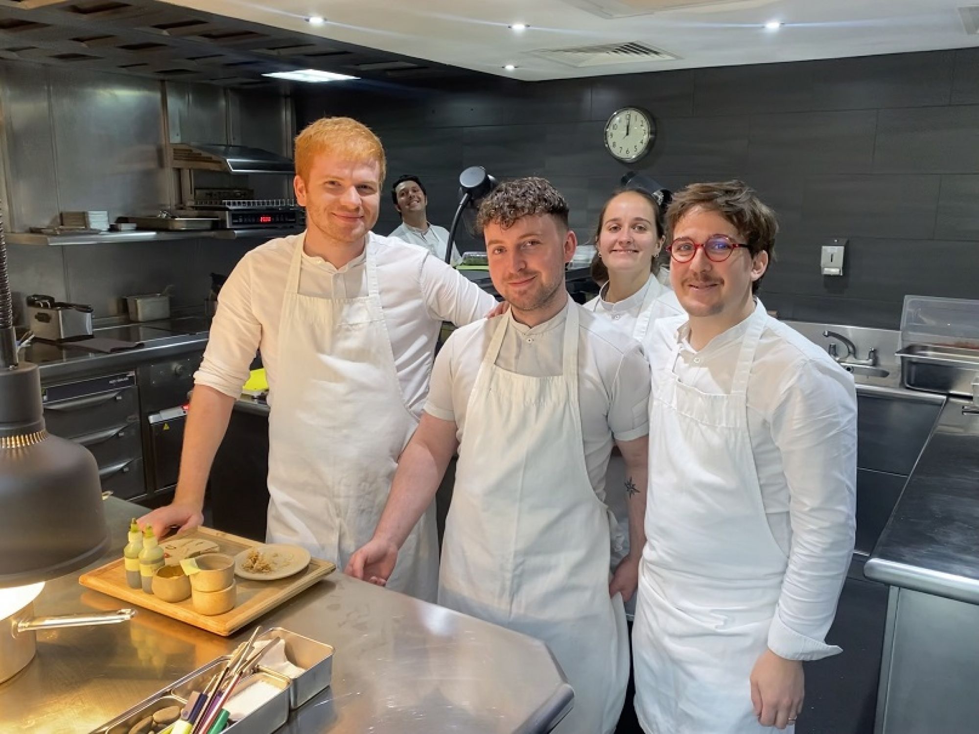 Lewis with colleagues in the kitchen