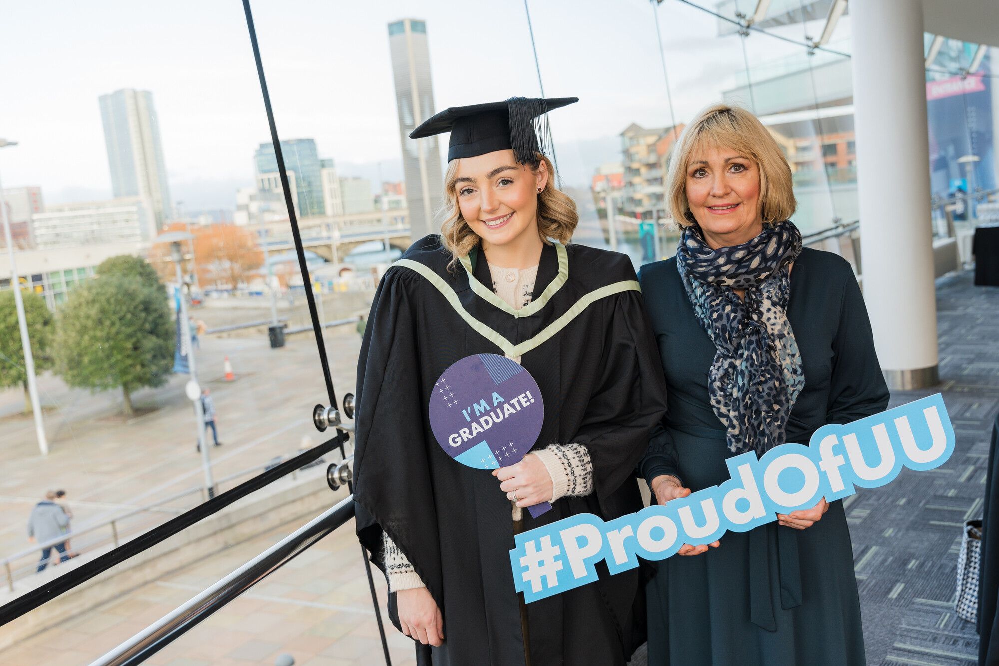 A graduate posing for a photograph with her mother