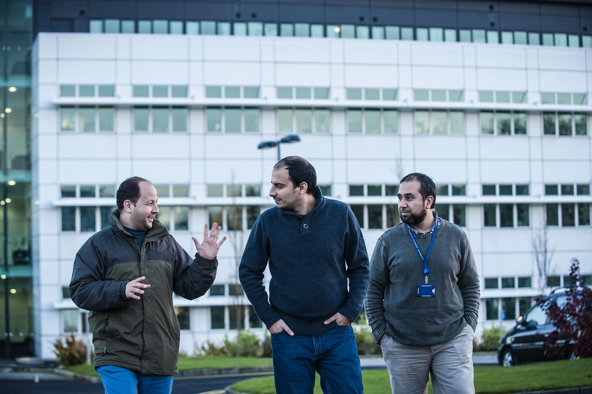 International students photographed with the Centre for Molecular Biology building in the background