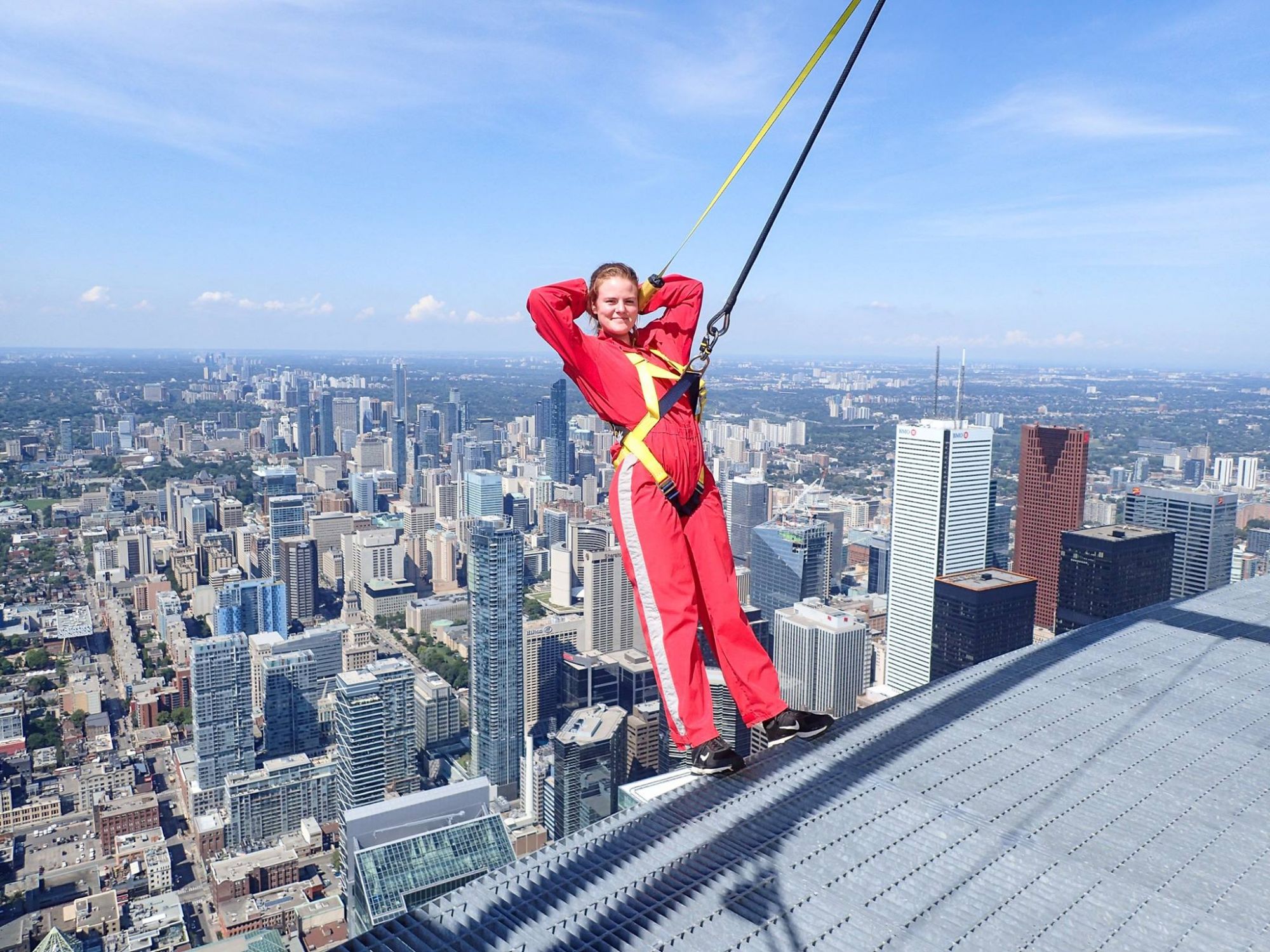 Eva with harness on hanging off bridge.