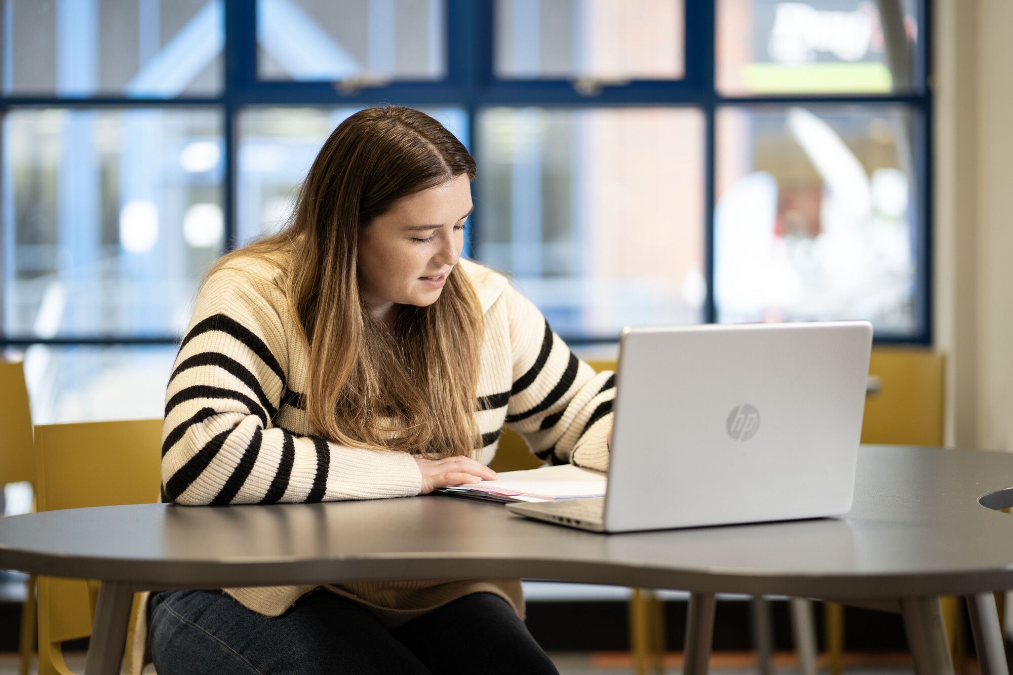 Student researching on a laptop