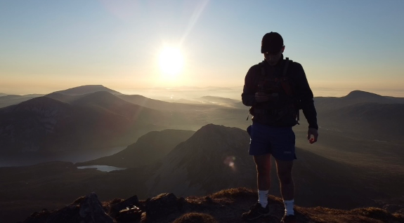 Silhouette of student on mountains 