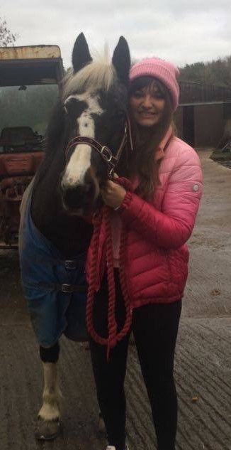 Smiling girl with horse