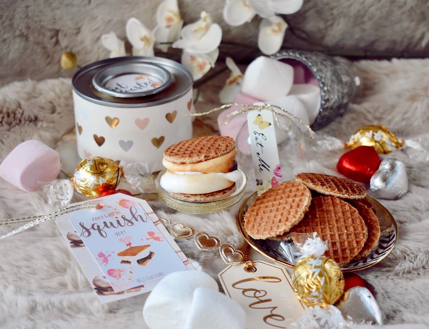 Marshmallows, mini pancakes and biscuits on top of bed.  