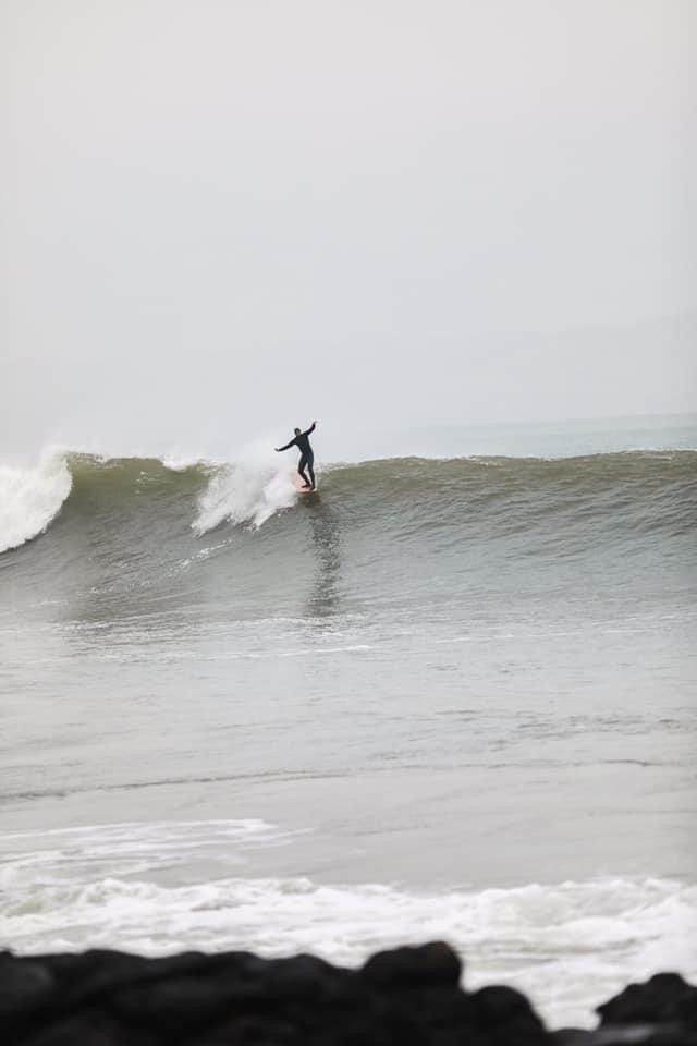 John surfing a wave.