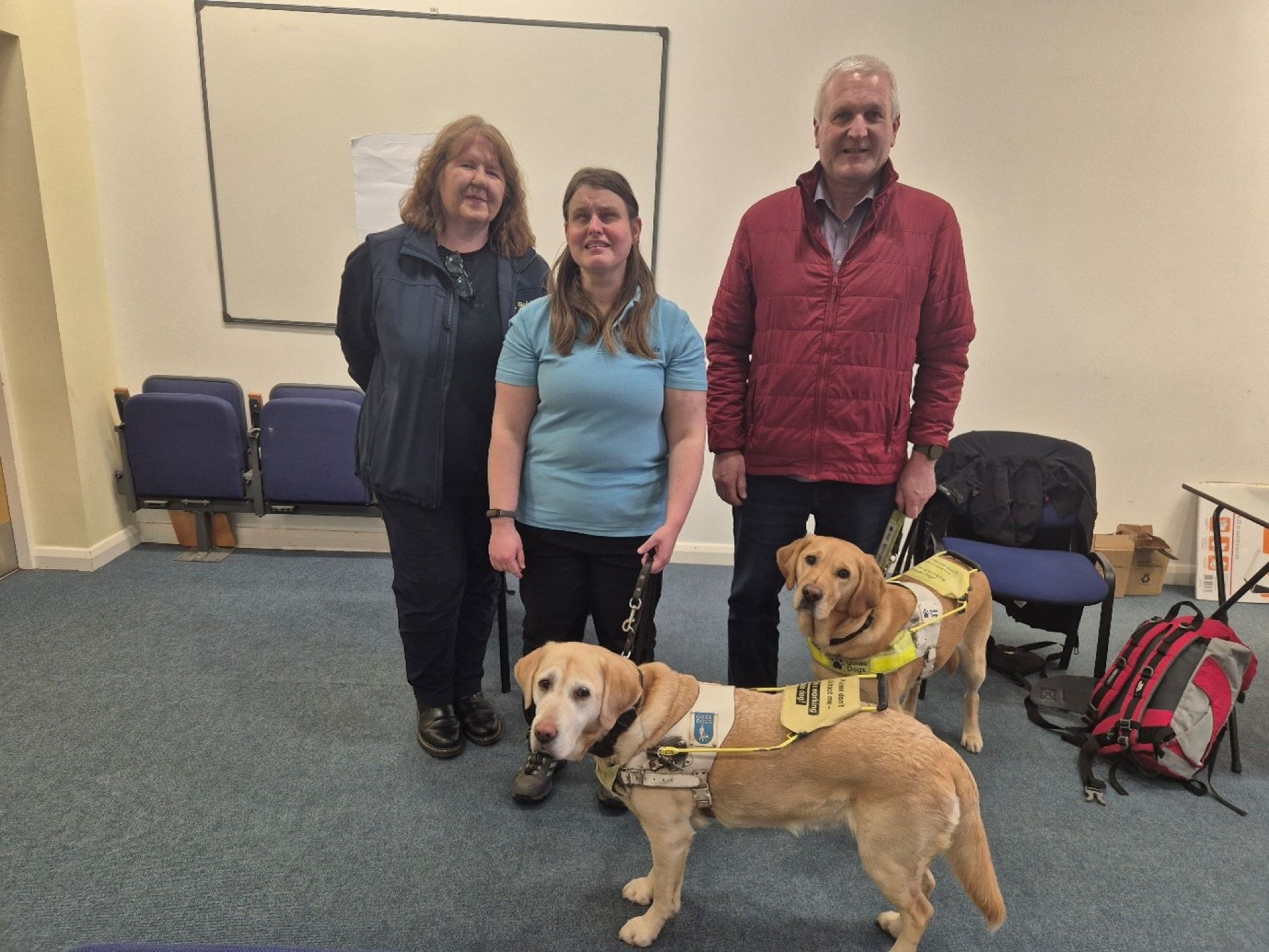 Two visitors from Guide Dogs NI with their guide dogs