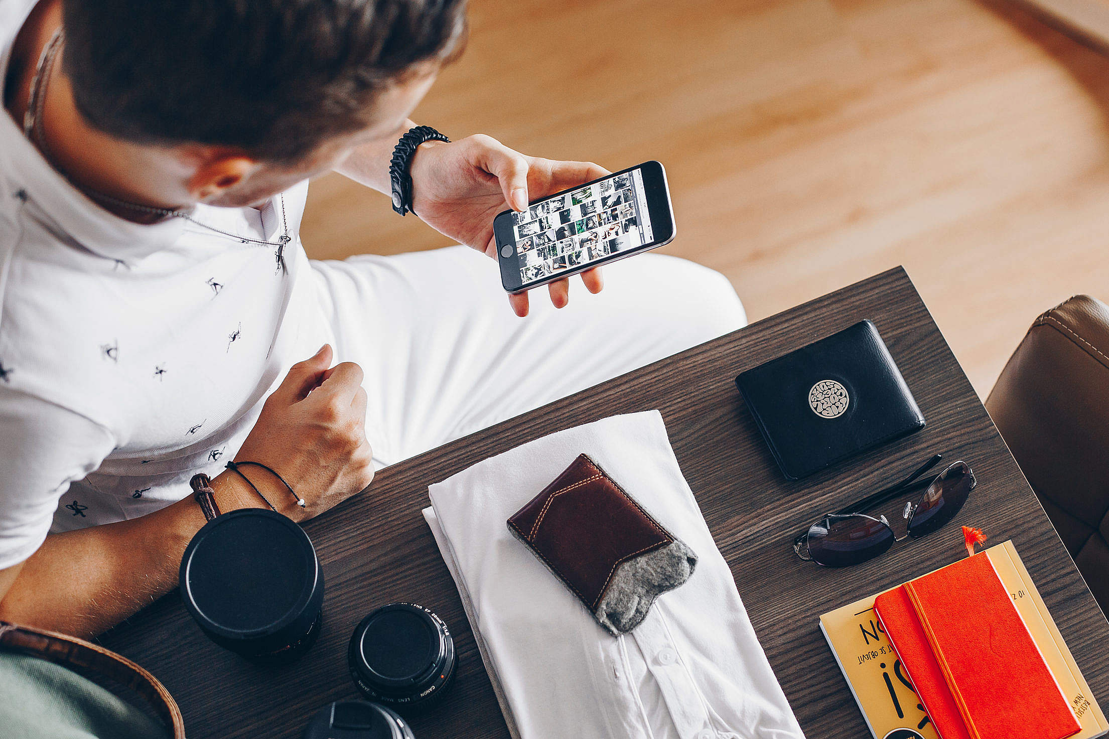 Man sitting while looking on his phone