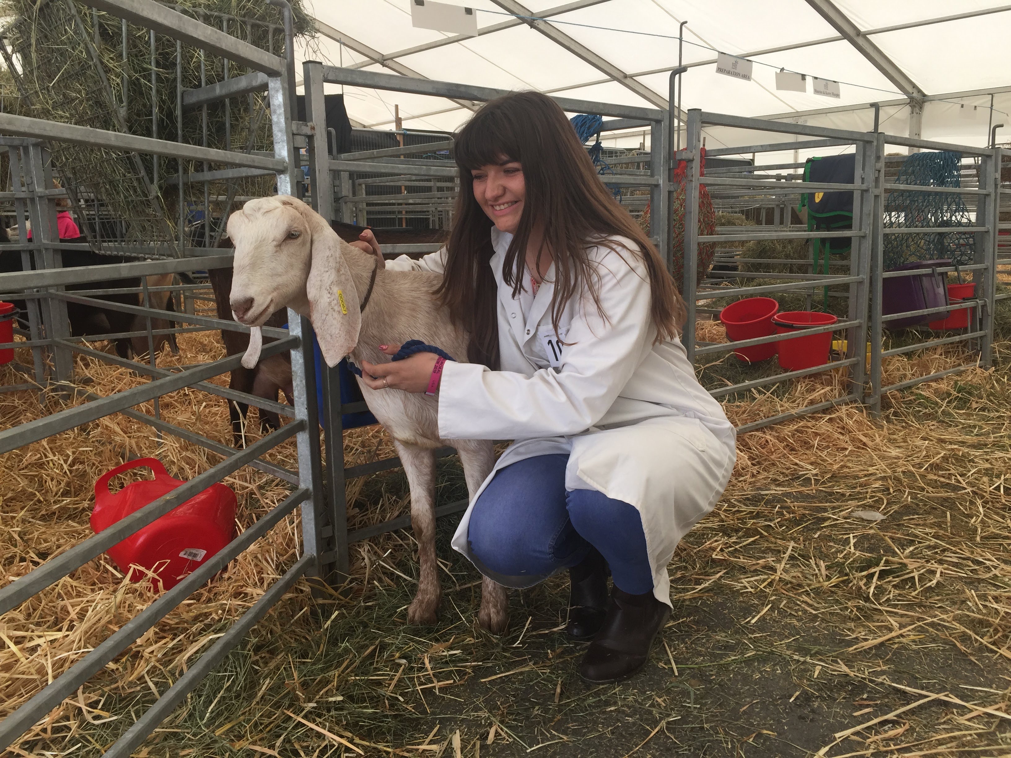 Smiling girl with goat