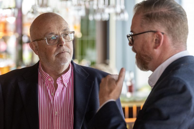 Two guests having a conversation by the bar in the Academy Restaurant.