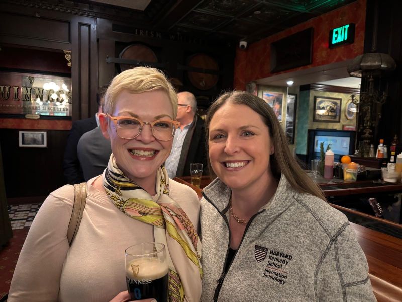 two women posing with drinks