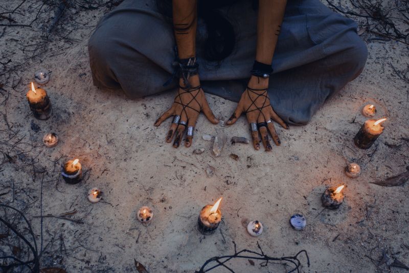 Woman with candle deep in forest