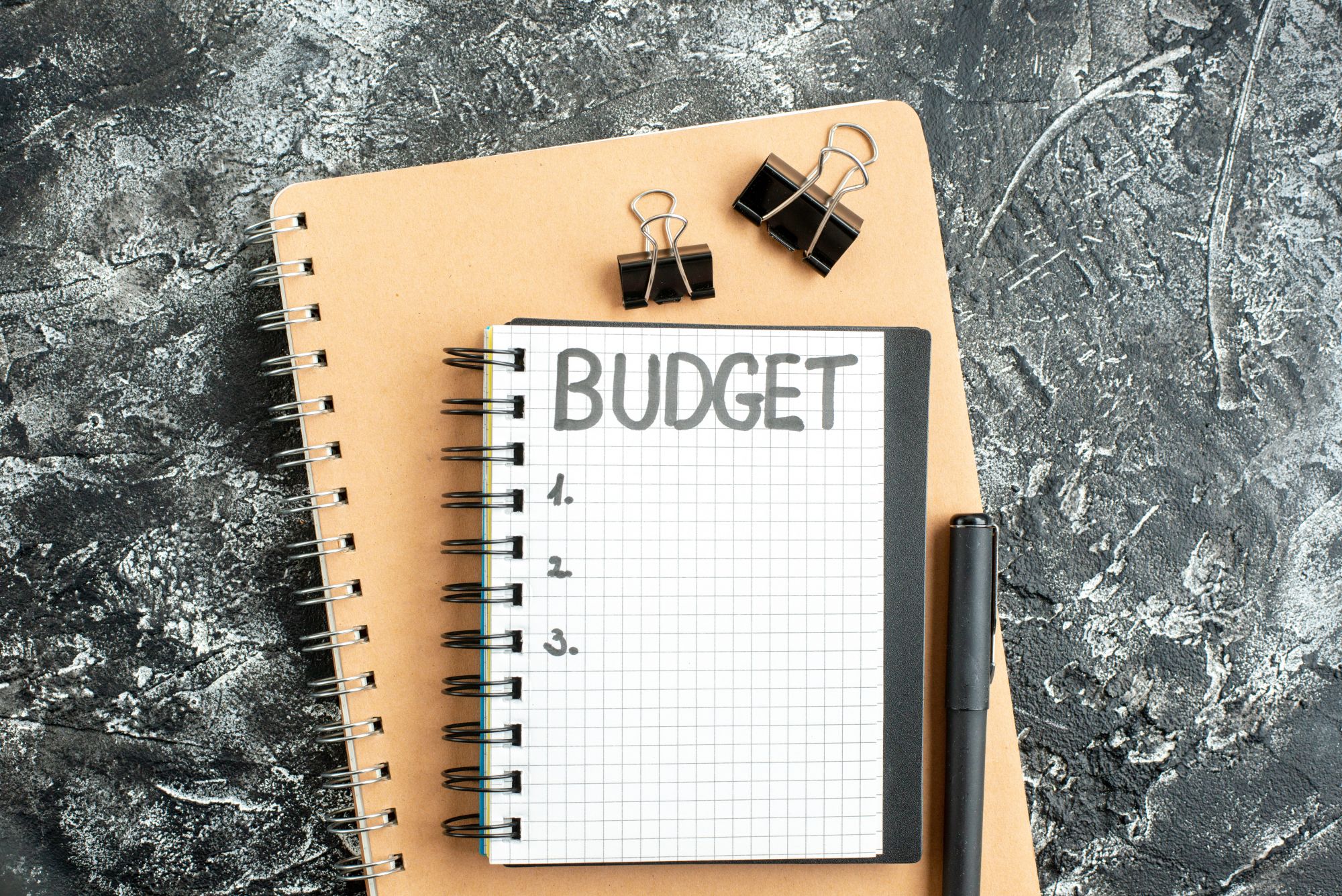 top view budget written note on notepad with pen on dark background gray student color school money