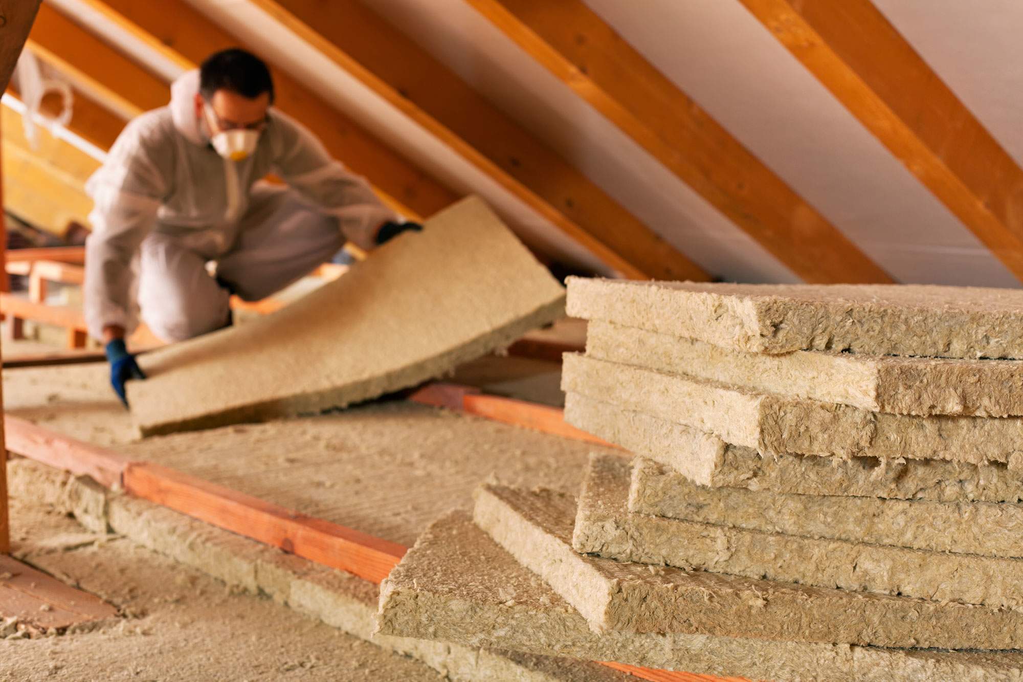Man installing loft insulation