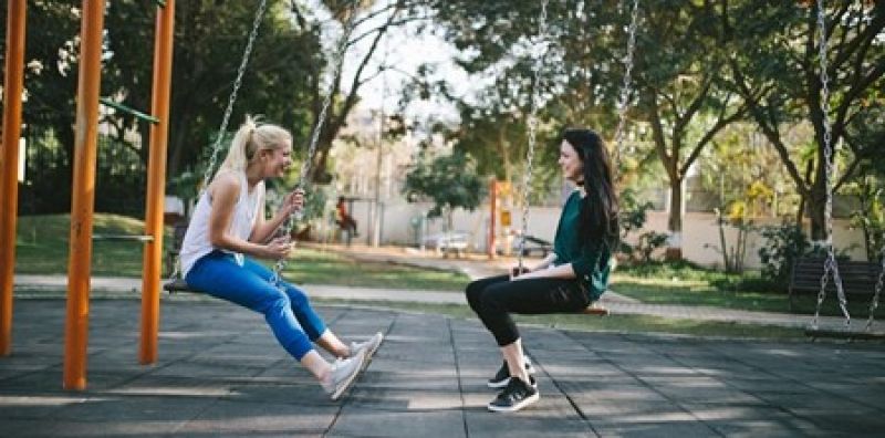 Friends on swings