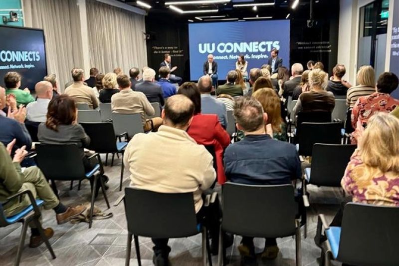 Image of the back of the audiences heads while the panellists are talking at the \'Where AI Meets Leadership\' event 